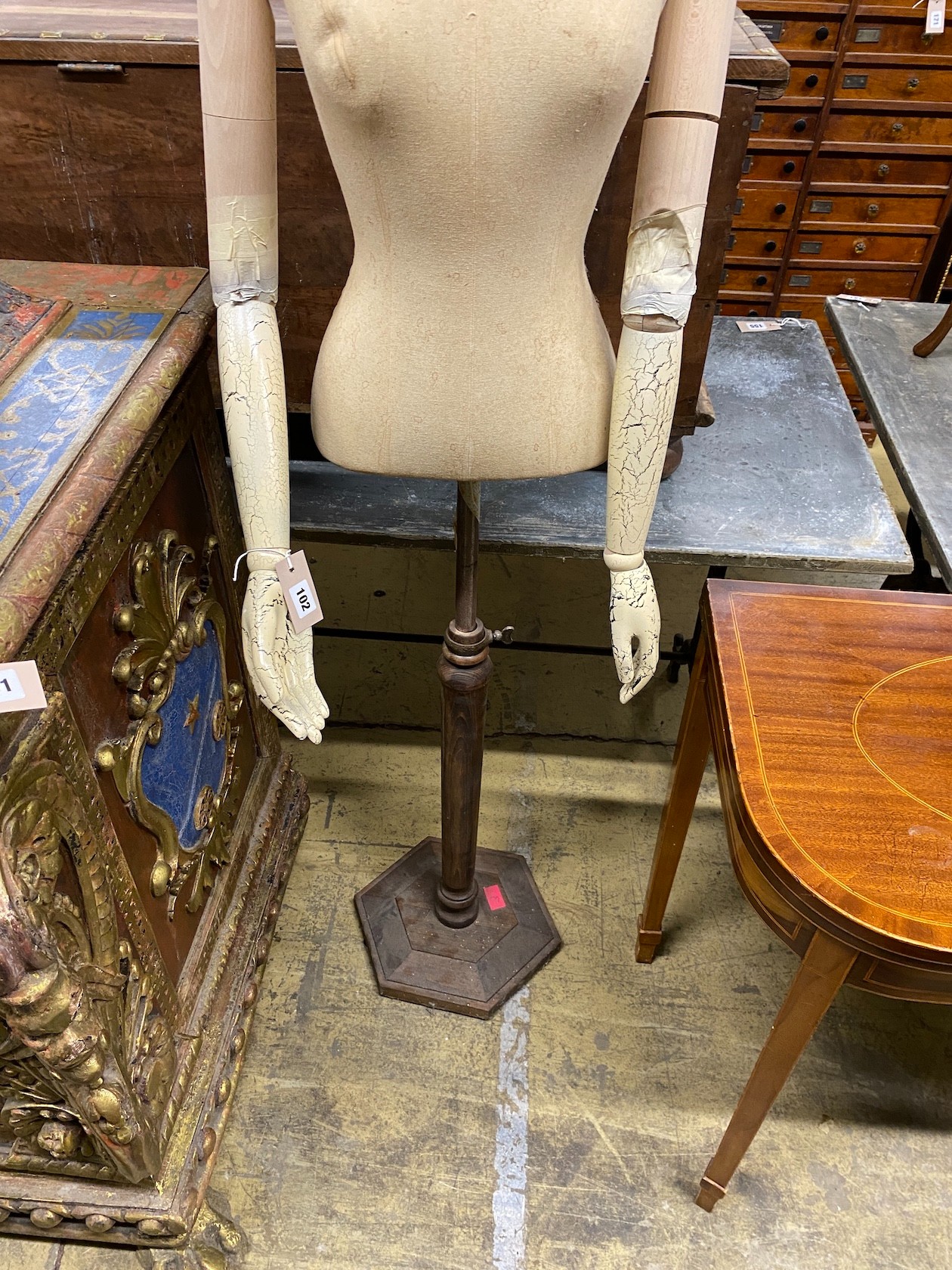 A Victorian style canvas, beech and composition mannequin on telescopic stand
